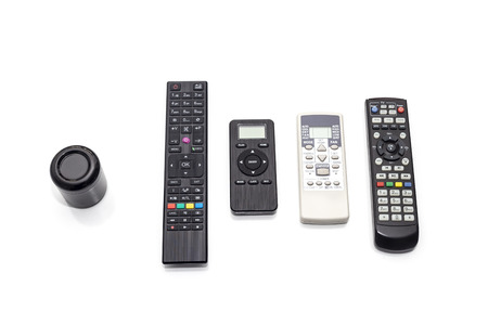 Universal ir and wifi remote with voice activation next to old fashioned remotes with buttons...