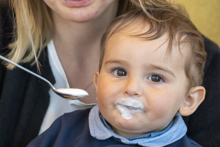 Very cute baby boy with milk mustache smiling at the camera.の写真素材