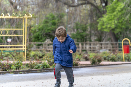 Young boy running around in an outdoor parkの写真素材