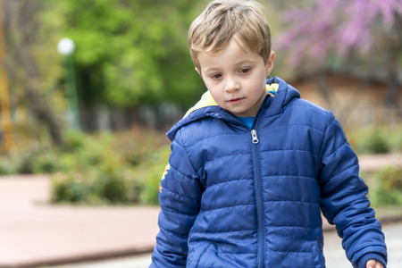Young boy walking around in a outdoors parkの写真素材