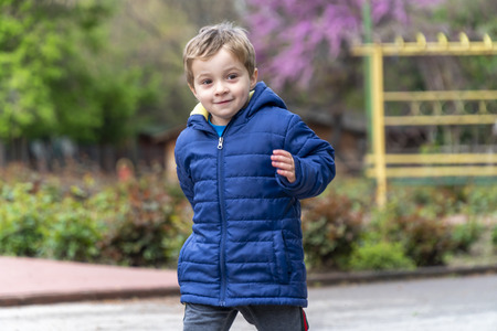 Young boy running around in an outdoor park