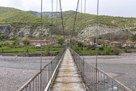 Very old and rusty suspension bridge over Borovitsa river in the Rhodope mountain in Bulgariaの写真素材