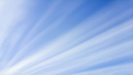 Clouds formed as straight lines resembling sunbeams from an eclipseの写真素材