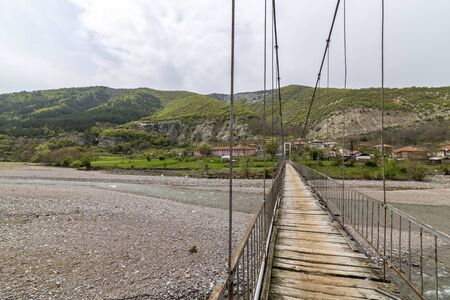 Very old and rusty suspension bridge over Borovitsa river in the Rhodope mountain in Bulgariaの写真素材