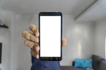 Man shwing smartphone to the camera with blank screenの写真素材