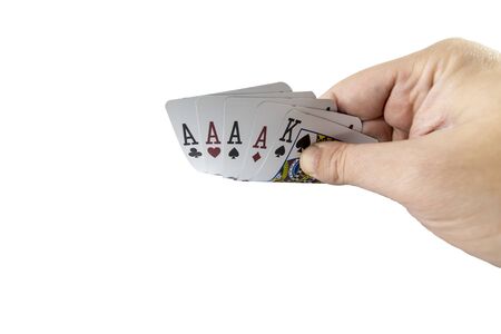 Low angle view of a hand showing poker cards isolated on white background. Gambling concept.の写真素材