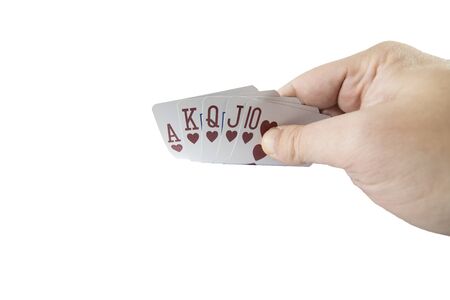 Low angle view of a hand showing poker cards isolated on white background. Gambling concept.の写真素材