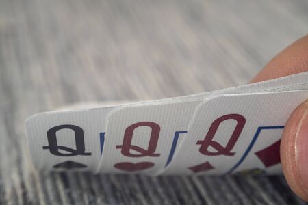 Low angle closeup view of a male hand picking up and showing cards from a casino table