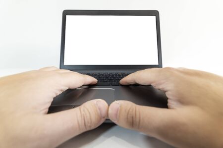 Low angle pow view of a man typing on a laptop keyboardの写真素材