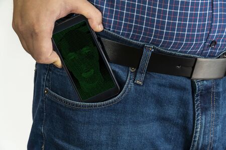 Man putting a smartphone in his pocket with AI personal assistant on the screenの写真素材
