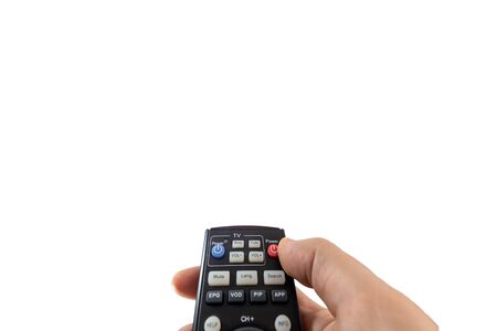 Person poining a TV remote and pressing the power button isolated on white backgroundの写真素材