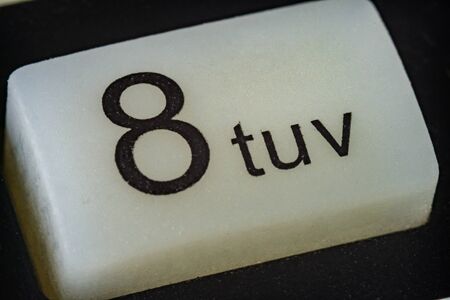 Extreme macro of number 8 button with lettersの写真素材