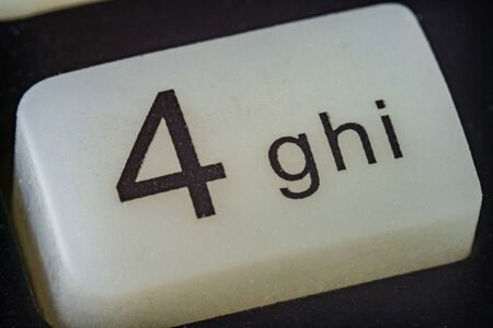 Extreme macro of number 4 button with letterの写真素材