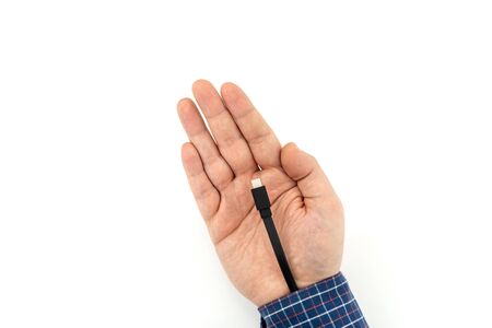 Augmented human hand with the cable sticking out for transferring data and charging the battery