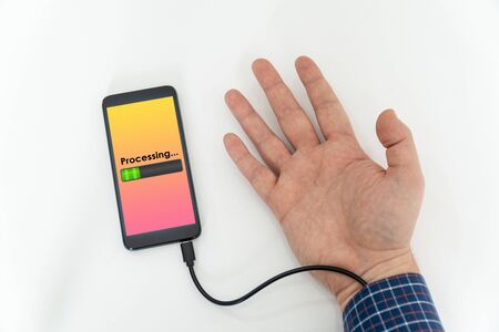 Augmented human hand connected to a smartphone via usb cable and transferring data. Hologram notification appearing on the handの写真素材