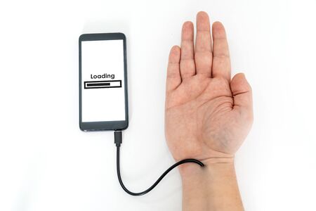 Augmented human hand connected to a smartphone via usb cable and transferring data. Hologram notification appearing on the handの写真素材