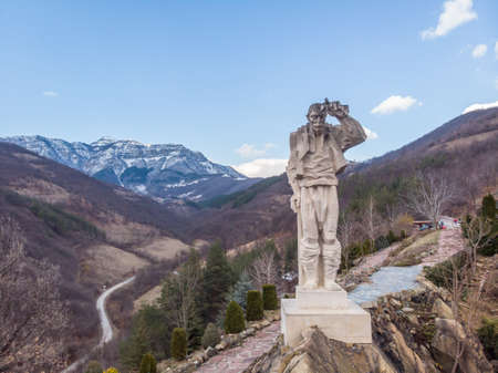 Diado Yotso gleda monument located in the Vratsa region near Ochindol village in Bulgaria. Old person looking at the railway in the distance.のeditorial素材
