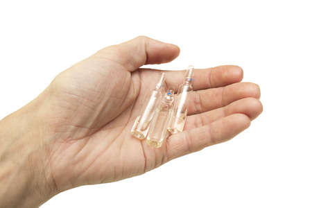ampoules with liquid in handの写真素材