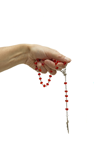 rosary in his hand on a white backgroundの写真素材