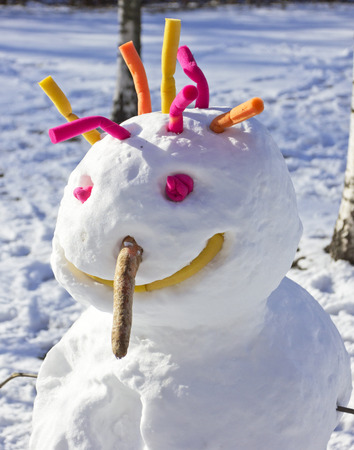 cheerful snowman on a snowy fieldの写真素材