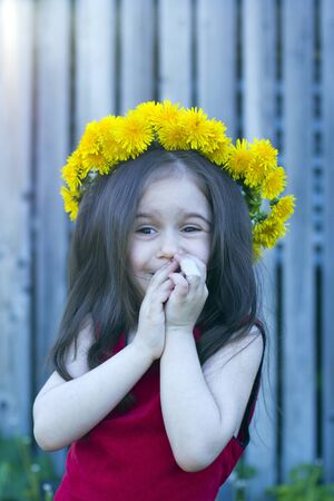 happy little girl in floral wreathの写真素材