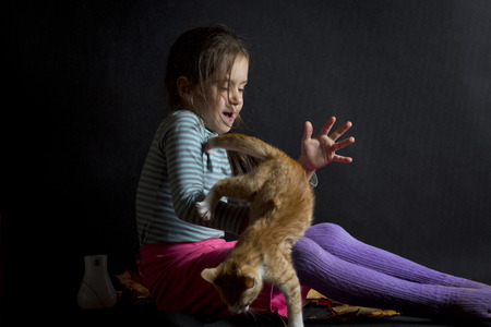 beautiful little girl and ginger kittenの写真素材