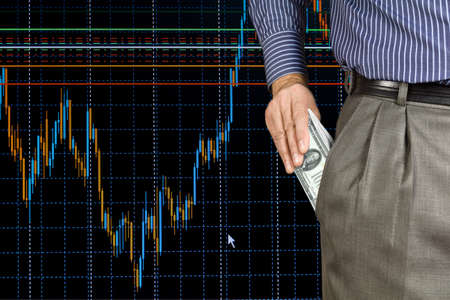 A man puts money in the pocket on the background schedule of trading 