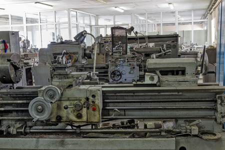 Large covered with dirt and metal shavings lathes.
