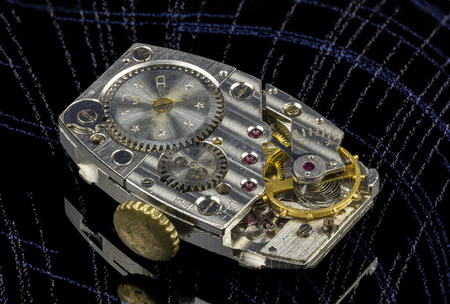 The mechanism of old wristwatches closeup on a dark background.