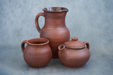 Clay jugs on a gray background. Kitchen utensils.
