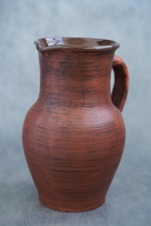Ceramic earthenware vase with a cup of coffeeの写真素材