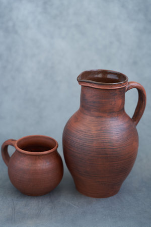 Clay jug and jug on a gray background. Vintage style.の写真素材