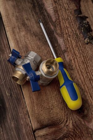 Screwdriver and screws on a background woodの写真素材