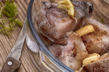 raw fish is cut by slices with seasoning 