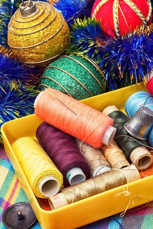 box of thread and needles and Christmas tree decorationsの写真素材