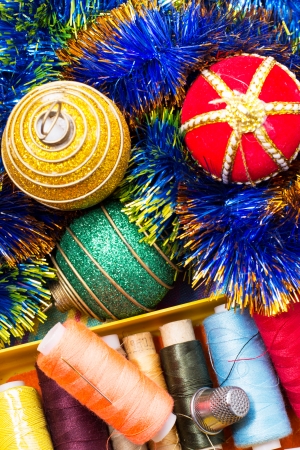 box of thread and needles and Christmas tree decorationsの写真素材
