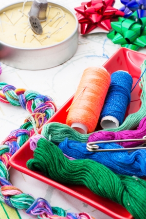 two spools of thread and thread for embroidery of different shadesの写真素材