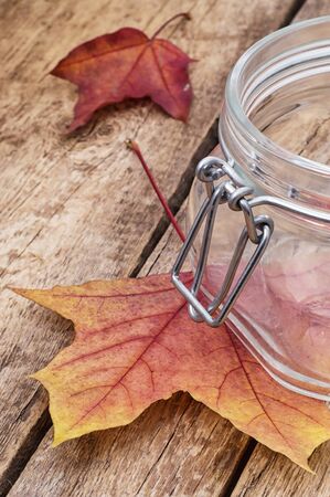 Desk with empty dishes and hazelnut fallen foliageの写真素材