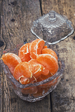 broken into slices tangerine in a glass vaseの写真素材