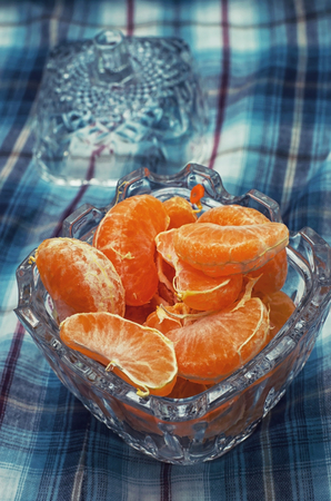 broken into slices tangerine in a glass vaseの写真素材