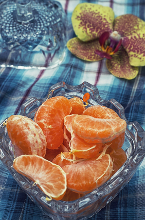 broken into slices tangerine in a glass vaseの写真素材