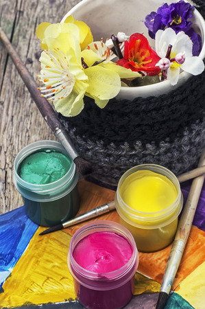 paint for painting in cans and composition with flowers in the springの写真素材