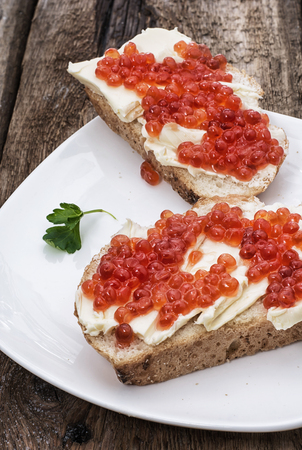 Sandwiches delicacies with red caviar,butter and breadの写真素材