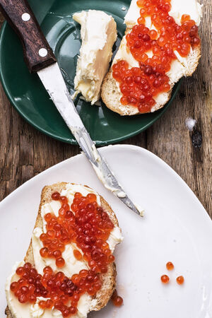 Sandwiches delicacies with red caviar,butter and breadの写真素材
