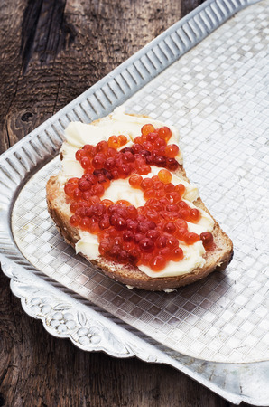 Sandwiches delicacies with red caviar,butter and breadの写真素材