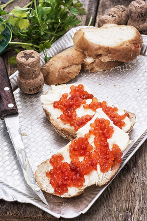 Sandwiches delicacies with red caviar,butter and breadの写真素材