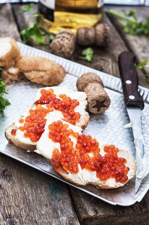 Sandwiches delicacies with red caviar,butter and breadの写真素材