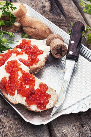 Sandwiches delicacies with red caviar,butter and breadの写真素材
