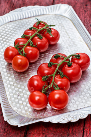 delicious fresh tomatoes on branchesの写真素材