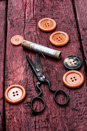 buttons and zipper on the background of sewing toolの写真素材